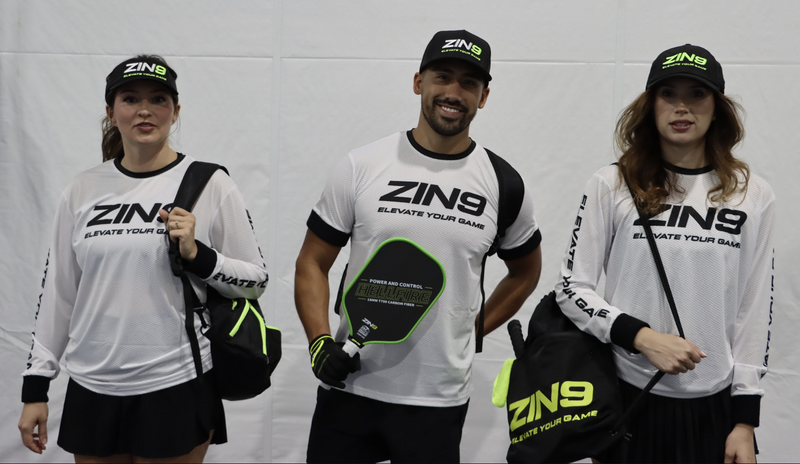 Three players in ZIN9 jerseys and hats with Hellfire paddles
